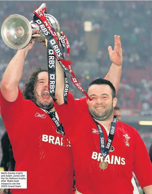  ??  ?? Mefin Davies (right) and Adam Jones with the Six Nations trophy after Wales beat Ireland to win the 2005 Grand Slam.