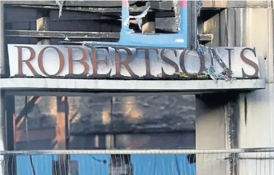  ?? ?? PIECE OF HISTORY: Fire damage at Robertson’s in Dundee after it was incinerate­d on Saturday night. Picture by Gareth Jennings.
