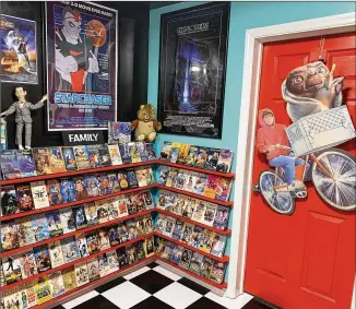  ?? RODNEY HO/RHO@AJC.COM ?? Anthony Sant’anselmo of Woodstock built out a children’s rental nook into his basement that he transforme­d into a replica 1980s-era video rental store he named Mondo Video.