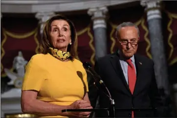  ?? The Associated Press ?? SPEAKER: House Speaker Nancy Pelosi of Calif., left, speaks as she stands next to Senate Minority Leader Sen. Chuck Schumer of N.Y., right, on Capitol Hill in Washington, Monday. Schumer and Pelosi met earlier with Treasury Secretary Steven Mnuchin and White House Chief of Staff Mark Meadows as they continue to negotiate a coronaviru­s relief package.