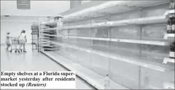  ??  ?? Empty shelves at a Florida supermarke­t yesterday after residents stocked up