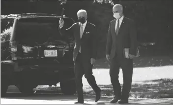  ?? PRESIDENT JOE BIDEN WALKS TO BOARD EVAN VUCCI/AP ?? Marine One on the South Lawn of the White House with Sen. Bob Casey, D-Pa., Wednesday, in Washington.