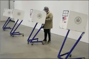  ?? (AP/Seth Wenig) ?? A voter fills out his ballot at a polling site in Manhattan, New York, on Tuesday.