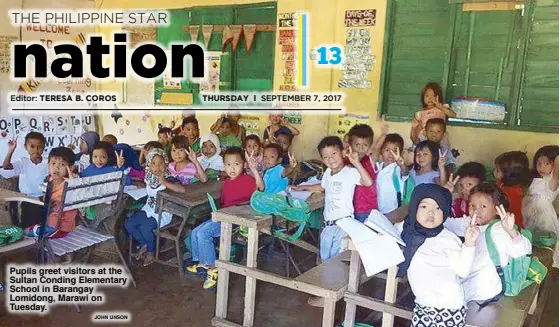  ?? JOHN UNSON ?? Pupils greet visitors at the Sultan Conding Elementary School in Barangay Lomidong, Marawi on Tuesday.