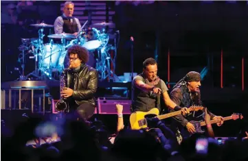  ??  ?? Bruce Springstee­n, second from right, performs with E Street Band members Max Weinberg, top left, Jake Clemons and Steven Van Zandt during their concert Sunday at Chesapeake Energy Arena in Oklahoma City.