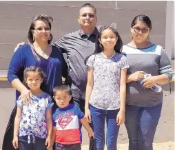  ?? COURTESY OF SOUTHWEST INDIAN FOUNDATION ?? The Becenti family, including Marine Corps veteran Johnathan, center, were recipients of a new home on the Navajo Nation through a Southwest Indian Foundation program.