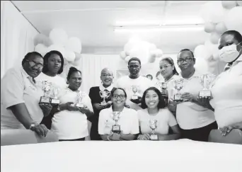  ?? ?? Team members at the Skin Clinic with trophies after being awarded for their sterling service