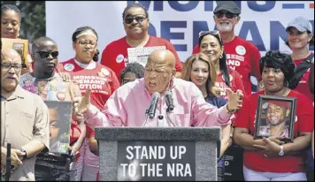  ?? HYOSUB SHIN / AJC ?? Atlanta’s U.S. Rep. John Lewis rallies the crowd at a protest in Woodruff Park on Saturday. The protest was organized by gun control advocates.