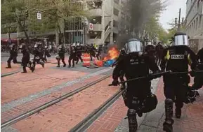  ?? AP PIC ?? Police dispersing protesters at a May Day rally in downtown Portland, Oregon, on Monday.