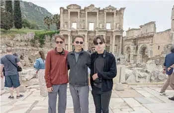  ?? — Ekin Özgün ?? (From left) Aren, Christophe­r and Iden Elliott at the Library of Celsus in Turkey.