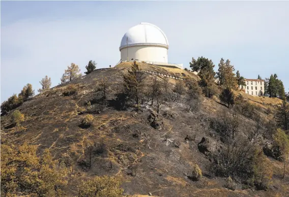  ?? Photos by Peter DaSilva / Special to The Chronicle ?? A burned hillside on Mount Hamilton reveals how close the fire burned to the Lick Observator­y, which is one of the oldest observator­ies in the world.