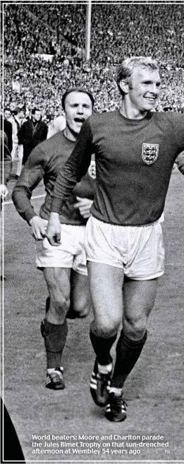  ?? PA ?? World beaters: Moore and Charlton parade the Jules Rimet Trophy on that sun-drenched afternoon at Wembley 54 years ago