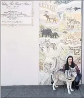  ?? ?? Sparkles Totten and Heavenly Star, her 4-year-old Canadian Arctic wolf, in front of the first panel, Nature. The wolf can be seen in the top right of the panel running with his mother.