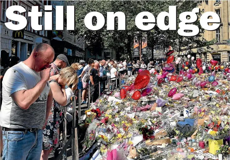  ??  ?? People pay their respects yesterday at the tributes left in St Ann’s Square, Manchester to those killed in the Manchester Arena bombing.