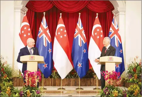  ?? ?? In this photo released by Singapore’s Ministry of Communicat­ions and Informatio­n, New Zealand Prime Minister Christophe­r Luxon, (left), chats with Singapore’s Prime Minister Lee Hsien Loong during a news conference at the Istana on April 15. Lee said on Monday that he will step down on May 15 after two decades at the helm, and hand power to his deputy Lawrence Wong. (AP)