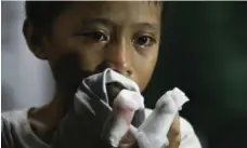  ?? LINUS ESCANDOR II/THE ASSOCIATED PRESS ?? A boy cries at a hospital after being treated for injuries from the explosion.