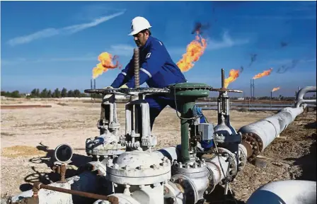  ?? — AP ?? Unusual practice: A worker operates valves at an oil field north of Basra. Iraq’s planned hedging programme will be a departure from usual business practices in the Middle East, where producers sell crude largely under long-term contracts with refiners.