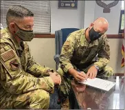  ?? STACEYGEIG­ER / U.S. AIR FORCE ?? ChiefMaste­r Sgt. Jason Shaffer (left), 88th Air Base Wing command chief, looks on while Col. Patrick Miller, 88th Air BaseWing and installati­on commander, signs aproclamat­ion forWomen’sEqualityD­ayonAug. 26. This year’s theme forWomen’s Equality Day is ‘Beyond theScopeof­Women’sSuffrage: 100Yearsof Progress,’ marking the 100th anniversar­y of the signing of the 19th Amendment affordingw­omen the right to vote.