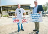  ?? MATTHEW HINTON/AP 2020 ?? Richard Windmann, left, and John Gianoli, members of the Survivors Network of those Abused by Priests, hold signs during a protest in Metairie, La.
