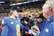  ?? Keith Srakocic / Associated Press ?? Pittsburgh quarterbac­k Kenny Pickett (8) greets offensive coordinato­r Mark Whipple after the team’s win over Virginia in the Atlantic Coast Conference Coastal Division championsh­ip on Nov. 20.