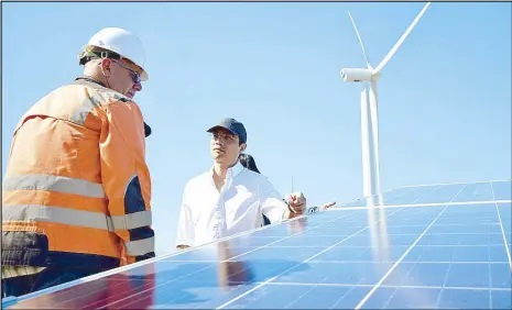  ??  ?? First Gen chairman and CEO Federico Lopez (right) at the Burgos wind and solar plant.