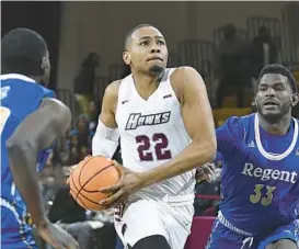  ?? UMES ATHLETICS ?? UMES graduate student forward Nathaniel Pollard Jr. drives to the basket between two Regent defenders during a game Feb. 2. “Last year, it was, get the MEAC title,” Pollard said of the players’ expectatio­ns.“This year, it’s, get to the national tournament.”