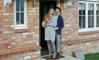  ??  ?? SIGNED UP: Tim and Kat in their new Millwood home at Heatherlan­ds in Heathfield