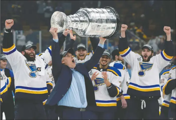  ??  ?? St. Louis head coach Craig Berube hoists the Stanley Cup after the Blues defeated the Boston Bruins in Game 7 last season to end a 52-year championsh­ip drought. The Blues strangely found some motivation in Laura Branigan’s old pop hit Gloria. — THE CANADIAN PRESS