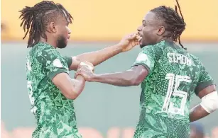  ?? ?? Moses Simon (R) celebrates with goalscorer, Ademola Lookman during the quarter final match against Angola yesterday in Abidjan