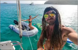  ?? PHOTO COURTESY OF JOHN JASO VIA THE NEW YORK TIMES ?? Former A's catcher John Jaso stands aboard his sailboat in the Caribbean Sea with his girlfriend Jayden Davila in the background. Jaso retired at 34, as the sea was calling.
