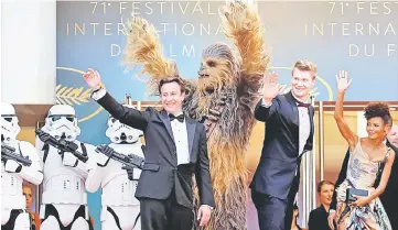  ??  ?? Screening of the film “Solo: A Star Wars Story” out of competitio­n at Cannes Film Festival on May 15. (From left to right) Producer Simon Emanuel and cast members Joonas Suotamo, Thandie Newton and Chewbacca pose and (below) On the red carpet arrivals...