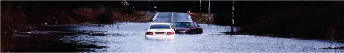  ??  ?? Swamped: Motorists tried but failed to navigate the flood water covering the A706 near the village of Forth, Lanarkshir­e, yesterday following heavy overnight rain