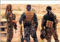  ?? PICTURE: AP ?? Members of the US-backed Syrian Democratic Forces look towards the northern town of Tabqa.