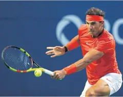  ?? AFP ?? Rafael Nadal plays a shot against Benoit Paire during their second round match.