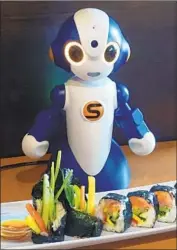  ?? Paul Boorstin ?? GO AHEAD, talk to the robots on the tables at the Junkichi Robata Izakaya restaurant in Seattle.