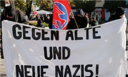  ?? Photograph: Michele Tantussi/Reuters ?? Protesters hold a banner reading ‘Against old and new Nazis!’ during a vigil in Guben on Saturday.