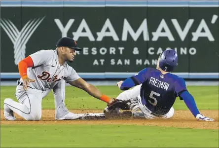  ?? Robert Gauthier Los Angeles Times ?? ANDY IBANEZ of the Tigers is too late with the tag on Freddie Freeman, who stole his career-high 20th base in the seventh Monday, making him 20 for 21 in steals. His “ability to get on base, steal second, go first to third — he’s as good as I’ve ever seen,” Dave Roberts said.