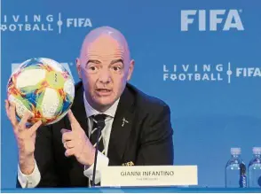  ?? — AP ?? Our decision: FIFA president Gianni Infantino holding a football as he speaks during a press conference after the FIFA council meeting on Friday.