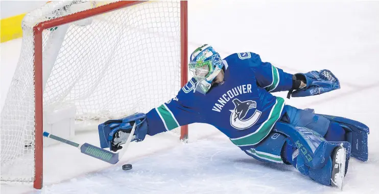  ?? — THE CANADIAN PRESS ?? Vancouver Canucks goalie Anders Nilsson loses his stick while making the save during the second period of Saturday’s game against the St. Louis Blues.