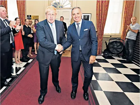  ??  ?? Sir Mark shakes Boris Johnson’s hand as the Prime Minister arrived at No 10 having just accepted the Queen’s invitation to form a government