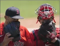  ?? JOHN BAZEMORE - THE ASSOCIATED PRESS ?? Boston Red Sox starting pitcher Nathan Eovaldi, left, talks with catcher Christian Vazquez as they walk off the field at the end of the second inning of a spring training baseball game against the Tampa Bay Rays, Friday, March 19, 2021, in Fort Myers, Fla.