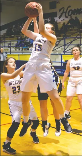  ?? Westside Eagle Observer/MIKE ECKELS ?? Annabelle Schopper (Decatur 15) brings down a rebound late in the second quarter of the Decatur-Fayettevil­le Haas Hall conference basketball contest at Peterson Gym in Decatur Dec. 4. Schopper led the scoring effort with 19, enabling the Lady Bulldogs to win their conference opener, 55-28, against the Lady Mastiffs.