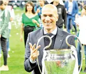  ?? — AFP photo ?? Real Madrid’s French coach Zinedine Zidane poses with the trophy after winning the UEFA Champions League final football match between Liverpool and Real Madrid at the Olympic Stadium in Kiev, Ukraine.