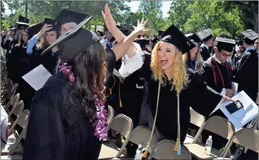  ??  ?? ABOVE: Kristen Reeves celebrates with classmates Saturday during Berry College’s Spring Commenceme­nt. BELOW: Malcholm Graham is congratula­ted following his commenceme­nt ceremony.Photos by Brant Sanderlin, Berry College