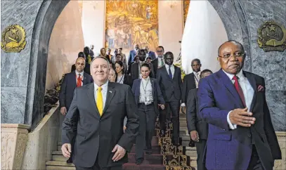  ?? Andrew Caballero-reynolds The Associated Press ?? Secretary of State Mike Pompeo, left, leaves with Angolan Foreign Minister Manuel Domingos Augusto after a news conference Monday at the Ministry of Foreign Affairs in Luanda, Angola. Pompeo was expected to arrive late Monday in Ethiopia.