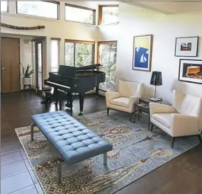  ??  ?? Clerestory windows light the living room of the house designed by Tasso Katselas. The owners found the blue bench at Pittsburgh Magazine's Ultimate House.