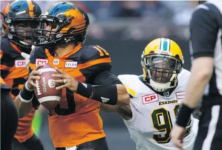  ?? — CP FILES ?? B.C. Lions quarterbac­k Jonathon Jennings evades the grasp of Edmonton’s Da’Quan Bowers during Saturday’s night’s opener at B.C. Place. Jennings was sacked five times in a 30-27 setback.