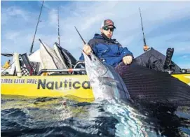  ?? JORGE BUSTAMANTE/COURTESY ?? Austin Collins of Delray Beach with one of the two sailfish that he caught and released off Pompano Beach to win the Extreme Kayak Fishing Tournament Sailfish Smack Down.