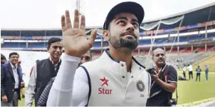  ??  ?? BANGALORE: Captain of the Indian cricket Test team Virat Kohli waves to supporters after rains led to a draw of the second Test cricket match between India and South Africa at The M. Chinnaswam­y Stadium in Bangalore yesterday. — AFP