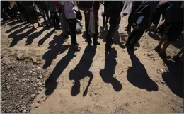  ?? ERIC GAY — THE ASSOCIATED PRESS ?? Migrants wait to be processed by the U.S. Customs and Border Patrol after they crossed the Rio Grande and entered the U.S. from Mexico in October in Eagle Pass, Texas.